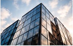 Glass office building facade viewed upward